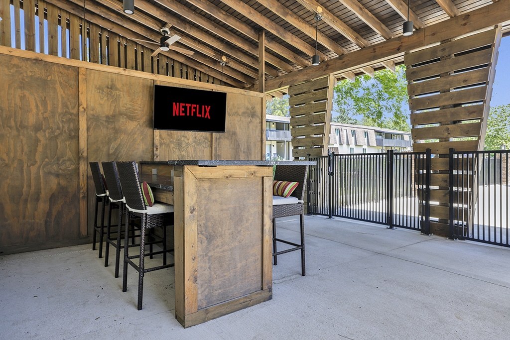 A wooden bar with a Netflix sign on the wall.